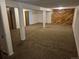 Unfinished basement with a brown carpet and wood wall at 2750 S Rifle St, Aurora, CO 80013