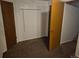 Unfinished basement with a brown carpet and multiple doors at 2750 S Rifle St, Aurora, CO 80013