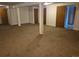 Unfinished basement with support columns and brown carpet at 2750 S Rifle St, Aurora, CO 80013