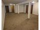Unfinished basement with multiple support columns and brown carpet at 2750 S Rifle St, Aurora, CO 80013