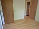 A bedroom with hardwood flooring, a wooden door, and white walls at 2750 S Rifle St, Aurora, CO 80013