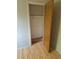 A closet with an open wooden door and an installed storage rack with a hanging rod at 2750 S Rifle St, Aurora, CO 80013