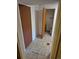 Hallway leading to small bathroom with tile flooring and storage closet on the left at 2750 S Rifle St, Aurora, CO 80013