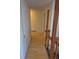 Hallway features hardwood floors, with a wooden railing, and a glimpse of doorways leading to other rooms at 2750 S Rifle St, Aurora, CO 80013