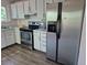 Efficient kitchen with stainless steel appliances, white cabinetry, and ample counter space for meal preparation at 2750 S Rifle St, Aurora, CO 80013