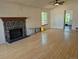 Spacious living room with hardwood floors, stone fireplace, vaulted ceilings, and natural light from large windows at 2750 S Rifle St, Aurora, CO 80013