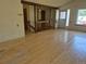 Bright living room with hardwood floors and wooden bannister featuring an open layout to other rooms in the house at 2750 S Rifle St, Aurora, CO 80013