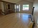 Sun-filled living room with gleaming hardwood floors, offering open access to the entryway and an adjacent room at 2750 S Rifle St, Aurora, CO 80013