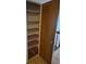 View of a pantry with shelving units and an open wooden door at 2750 S Rifle St, Aurora, CO 80013