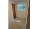 Small room with tile floor, window, and closet awaiting remodel and personalization at 2750 S Rifle St, Aurora, CO 80013