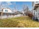 Fenced backyard with green grass and side of home, set against a blue sky at 19257 E Legend Ave, Parker, CO 80134