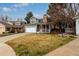 A traditional home with a stone chimney, a covered front porch and a manicured lawn at 19257 E Legend Ave, Parker, CO 80134