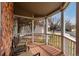 Cozy covered front porch with wooden flooring, white railings, and comfortable seating for relaxing outdoors at 19257 E Legend Ave, Parker, CO 80134