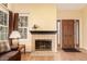 Inviting living room featuring a cozy fireplace, hardwood floors, and a warm, welcoming atmosphere at 19257 E Legend Ave, Parker, CO 80134