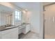 Bright bathroom boasts dual sinks, sleek countertops, and a glass-enclosed shower at 39420 Congress Ln, Elizabeth, CO 80107