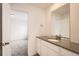 Bright bathroom featuring a modern vanity with white cabinets and gray countertop at 39420 Congress Ln, Elizabeth, CO 80107