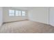 Carpeted bedroom with three windows offers neutral tones, and plenty of natural light at 39420 Congress Ln, Elizabeth, CO 80107