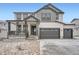 Charming two-story home with a covered front porch and an attached two-car garage at 39420 Congress Ln, Elizabeth, CO 80107