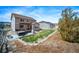 Spacious backyard with a lush lawn, a deck, a hot tub, and well-maintained landscaping at 6065 Clover Ridge Cir, Castle Rock, CO 80104