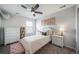 Bright bedroom featuring a bed, dresser, and window with natural light at 6065 Clover Ridge Cir, Castle Rock, CO 80104