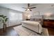 Comfortable bedroom with a tufted headboard, ceiling fan, and neutral tones at 6065 Clover Ridge Cir, Castle Rock, CO 80104