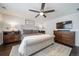Inviting bedroom featuring a tufted headboard, ceiling fan, and stylish furnishings at 6065 Clover Ridge Cir, Castle Rock, CO 80104