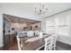 Bright dining area featuring an open concept design flowing into the kitchen, wood floors, and natural light at 6065 Clover Ridge Cir, Castle Rock, CO 80104