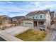 Two-story home with three car garage, neutral colors, landscaping and a inviting front porch at 6065 Clover Ridge Cir, Castle Rock, CO 80104