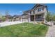 Charming two-story home with a well-manicured lawn, neutral-toned exterior, and three car garage at 6065 Clover Ridge Cir, Castle Rock, CO 80104