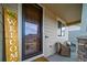 Inviting front porch with comfortable seating and a charming 'Welcome' sign at 6065 Clover Ridge Cir, Castle Rock, CO 80104