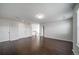 Hallway with hardwood floors, neutral walls, and multiple doors at 6065 Clover Ridge Cir, Castle Rock, CO 80104