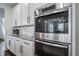 Stainless steel appliances, including oven, with white cabinets and granite counters at 6065 Clover Ridge Cir, Castle Rock, CO 80104