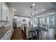 An inviting kitchen provides granite counters, stainless appliances, and island seating adjacent to the dining area at 6065 Clover Ridge Cir, Castle Rock, CO 80104