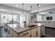 Bright kitchen featuring granite countertops, stainless steel appliances, and an island with sink, open to dining at 6065 Clover Ridge Cir, Castle Rock, CO 80104