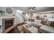 Inviting living room featuring a cozy fireplace, plush sectional sofa, and an open layout leading to the kitchen at 6065 Clover Ridge Cir, Castle Rock, CO 80104