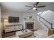Stylish living room with a fireplace, ceiling fan, and comfortable sectional sofa at 6065 Clover Ridge Cir, Castle Rock, CO 80104