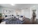 Cozy living room featuring hardwood floors, a sofa and chairs, and a glass coffee table at 6065 Clover Ridge Cir, Castle Rock, CO 80104