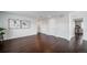Bright living room featuring hardwood floors, neutral walls, and two modern art pieces at 6065 Clover Ridge Cir, Castle Rock, CO 80104