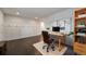 Office space with hardwood floors, white wainscoting, and a modern bookshelf at 6065 Clover Ridge Cir, Castle Rock, CO 80104