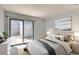 Bright bedroom with a sliding door to an outdoor space filled with natural light at 2488 S Victor St # E, Aurora, CO 80014