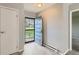 Bright foyer with gray plank flooring, showing the front door and an interior door at 2488 S Victor St # E, Aurora, CO 80014