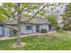 Charming home featuring a well-maintained lawn, mature tree, and inviting exterior at 2488 S Victor St # E, Aurora, CO 80014