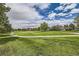 Picturesque golf course view with lush green grass, mature trees, and manicured fairways at 2488 S Victor St # E, Aurora, CO 80014