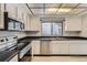 Modern kitchen with stainless steel appliances, plenty of cabinet space, and a view outside at 2488 S Victor St # E, Aurora, CO 80014