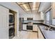 Well-lit kitchen equipped with stainless steel appliances and updated cabinets at 2488 S Victor St # E, Aurora, CO 80014