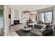 Open concept living room with fireplace, comfortable seating, and an adjacent dining area at 2488 S Victor St # E, Aurora, CO 80014