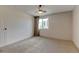 Bright bedroom with neutral carpet, large window, and a ceiling fan at 8555 Fairmount Dr # C202, Denver, CO 80247
