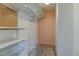 Walk-in closet featuring custom white shelving, adjustable wire basket storage, and neutral carpeting at 8555 Fairmount Dr # C202, Denver, CO 80247