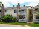 Inviting two-story condo with double balcony, stone chimney, and well-maintained lawn at 8555 Fairmount Dr # C202, Denver, CO 80247