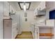 Efficient kitchen with white appliances, stylish subway tile backsplash, and modern wood accents at 8555 Fairmount Dr # C202, Denver, CO 80247